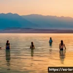 이스라엘에서 즐길 수 있는 아웃도어 액티비티 - A serene early morning scene at the Dead Sea with a diverse group of people wearing modest swimsuits...
